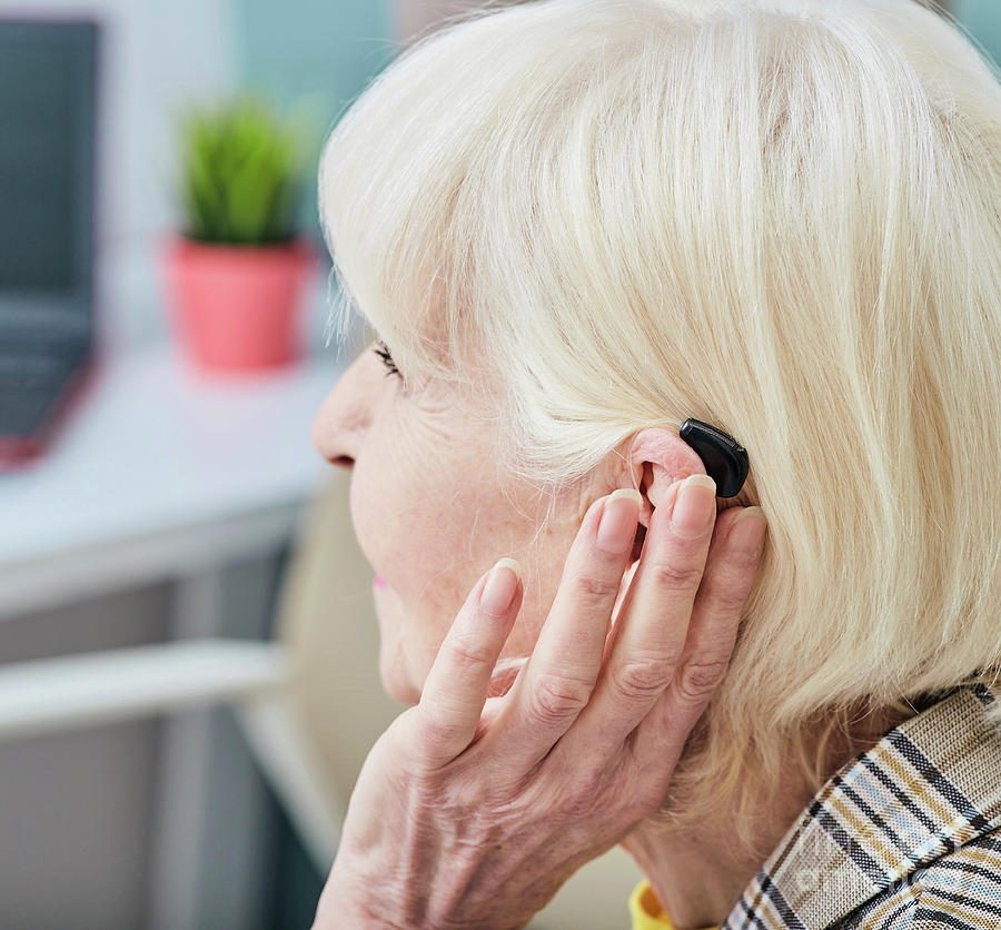 Senior Woman With Hearing Aid Photograph By Peakstock / Science Photo ...