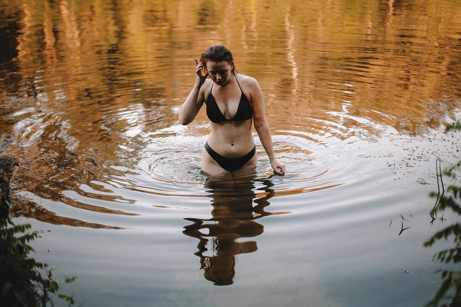 Fall Photograph - Sensual Woman In A Bikini Walking In River by Cavan Images