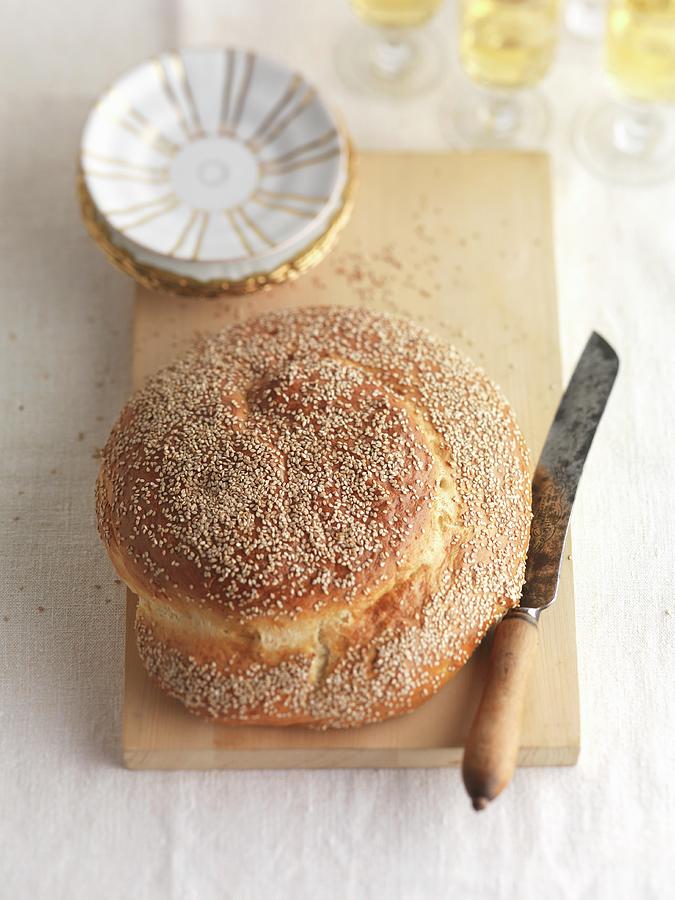 Sesame Seed Challa jewish Bread With A Knife On A Chopping Board Photograph by Joerg Lehmann