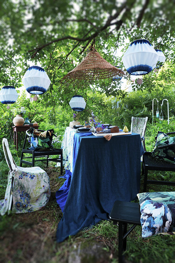 Set Table Below White And Blue Lanterns In Garden Photograph by Annette Nordstrom