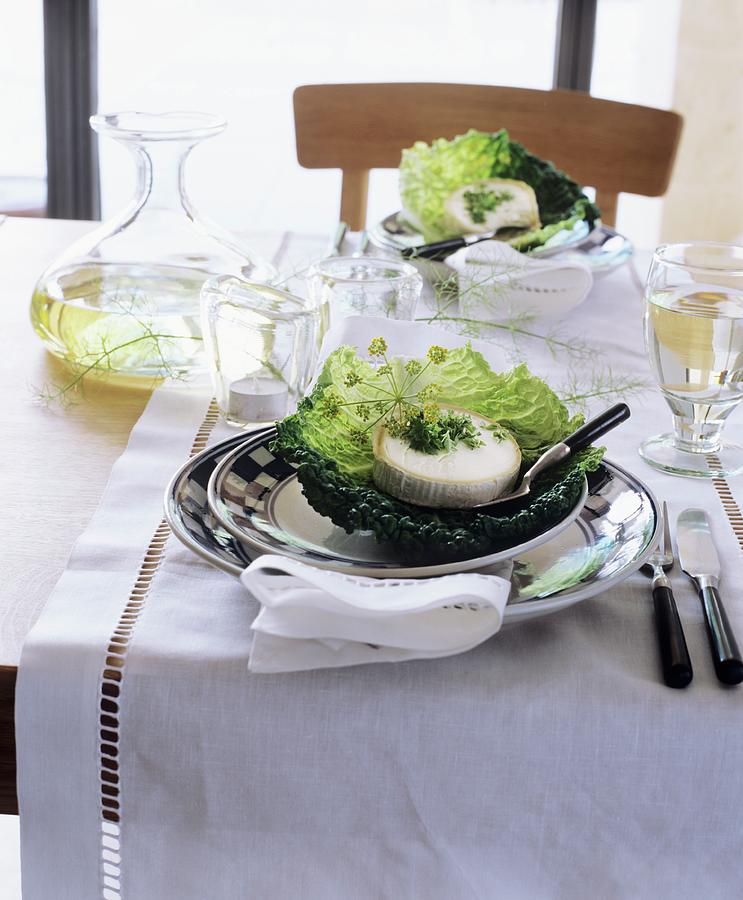 Set Table Decorated With Cheese In Cabbage Leaves Photograph by Matteo Manduzio
