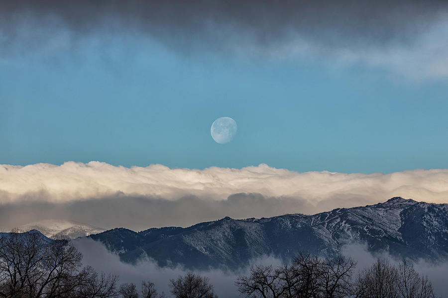 Setting Moon Between Cloud Layers Photograph by Tony Hake