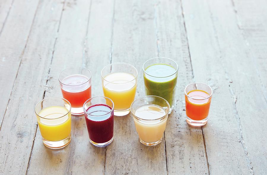 Seven Different Juices In Glasses On A Wooden Surface Photograph by Jalag / Stefan Bleschke
