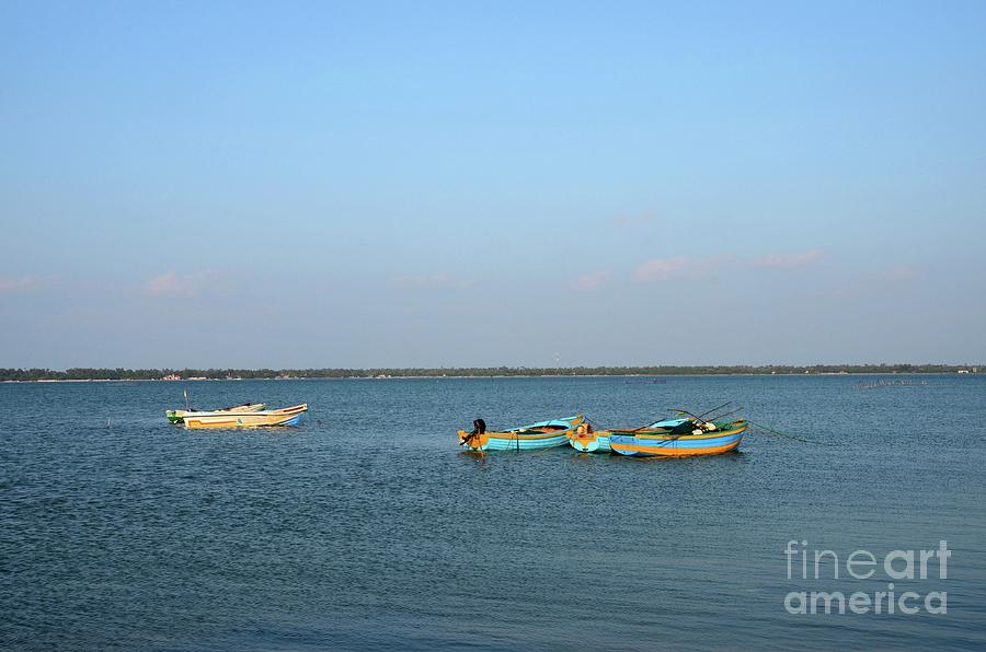Several blue and yellow boats moored anchored in waters of Jaffna Sri Lanka Photograph by Imran Ahmed