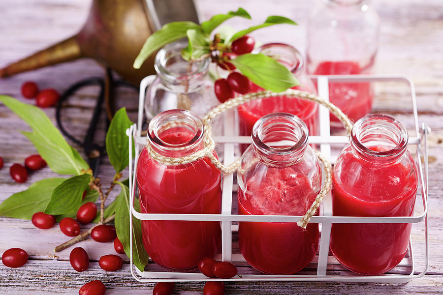 Several Bottles Of Cornelian Cherry Juice Photograph by Teubner Foodfoto