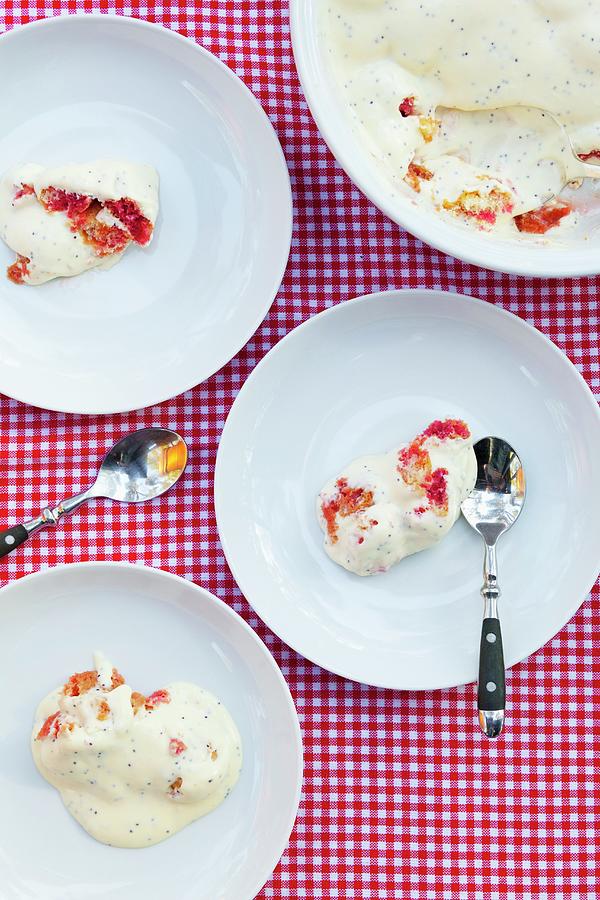 Several Dessert Dishes Filled With Raspberry Cake Topped With Vanilla-poppy Sauce Photograph by Studio Lipov