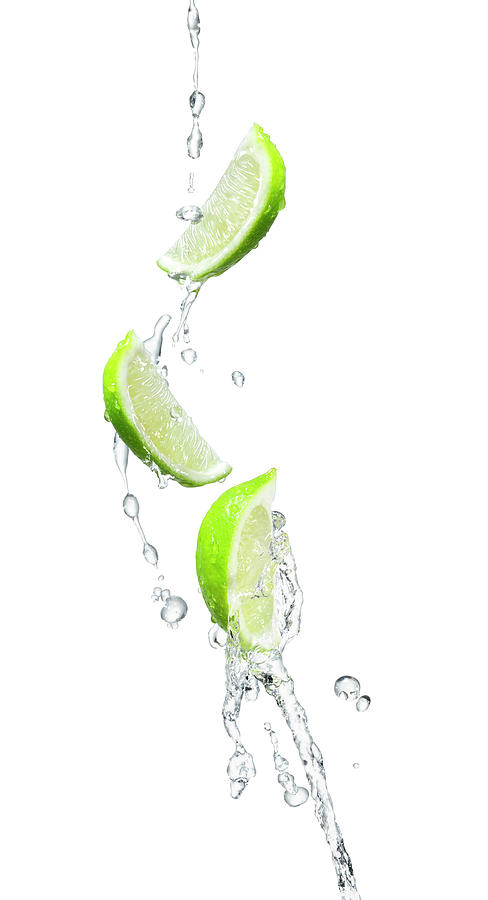 Several Limes In A Water Splash Photograph by Chris Stein