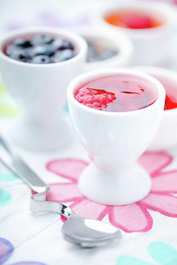 Several Mini Fruit Jellies In Eggcups Photograph by Komar
