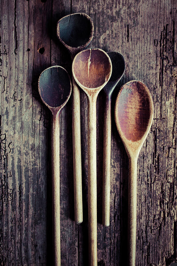Several Old Wooden Spoons On A Wooden Background Photograph by Katrin Winner