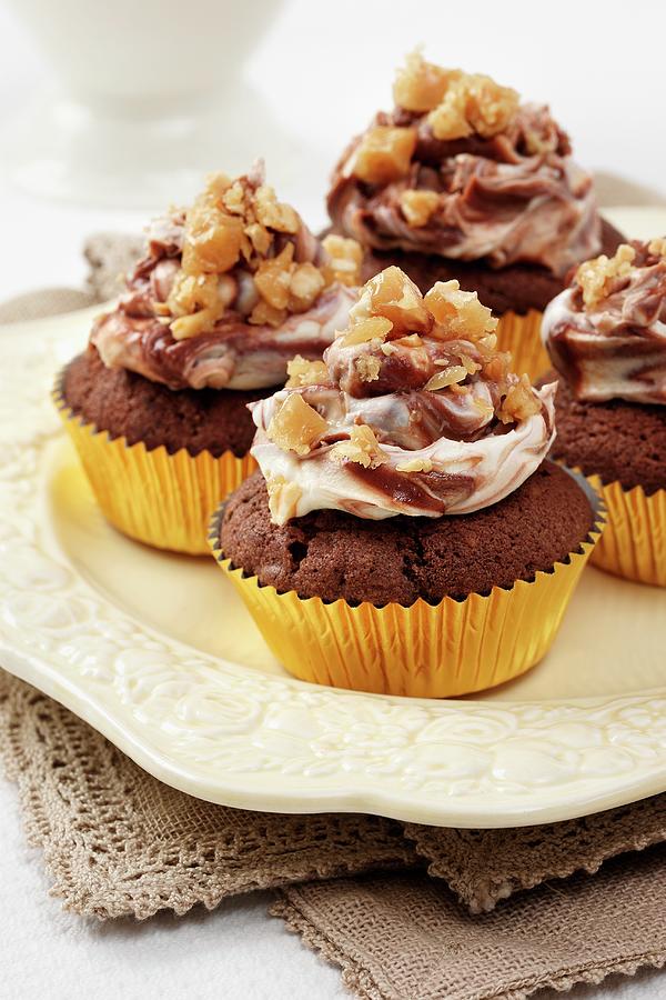 Several Peanut Butter And Chocolate Cupcakes With Chocolate And Cream Cheese Topping And Peanut Brittle Chips Photograph by Stuart Macgregor