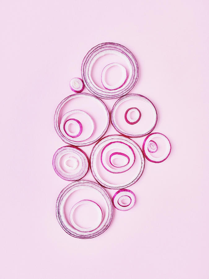 Several Red Onion Rings On A Pink Paper Background Photograph by Sylvia Meyborg
