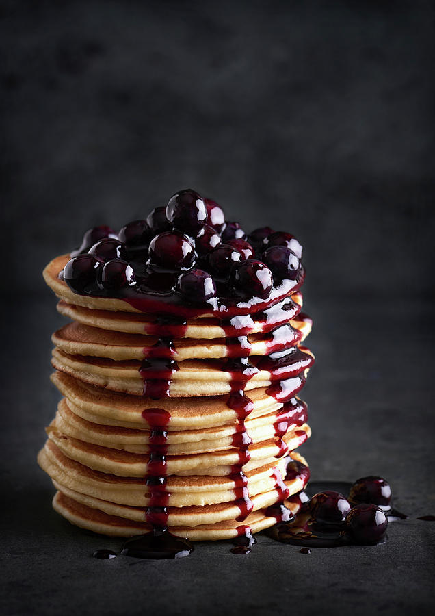 Several Stacked Pancakes With Cherries And Cherry Sauce Photograph by Sylvia Meyborg