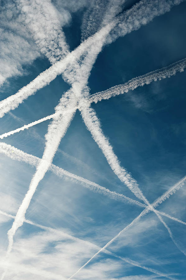 Several Vapor Trails Crossing In The Sky Photograph by Santosha