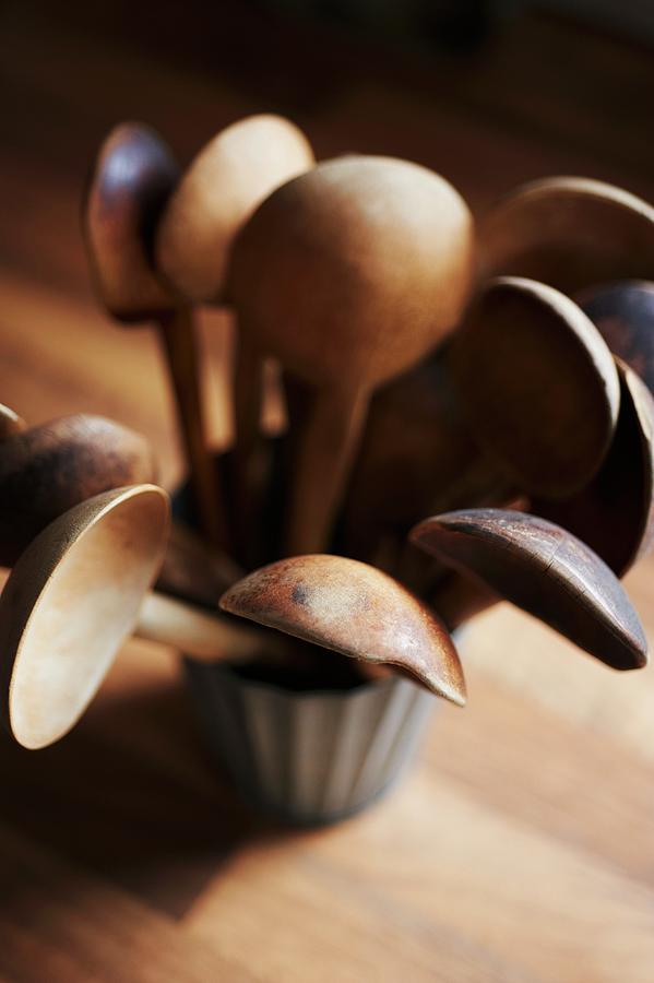 Several Vintage Wooden Spoons In Pot On Wooden Surface Photograph by Andrew Boyd