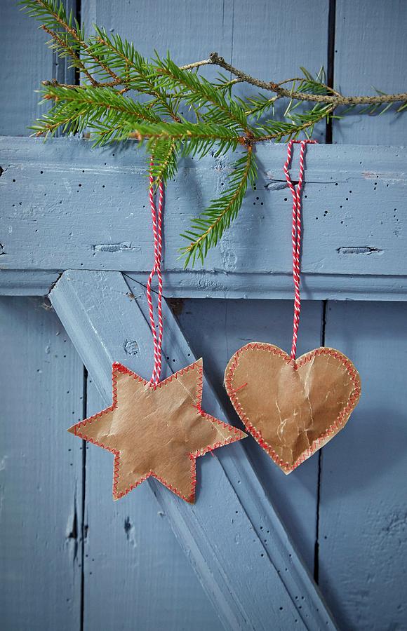 Sewn Paper Pendants Hung From Fir Branch On Blue Door Photograph by Martin Slyst