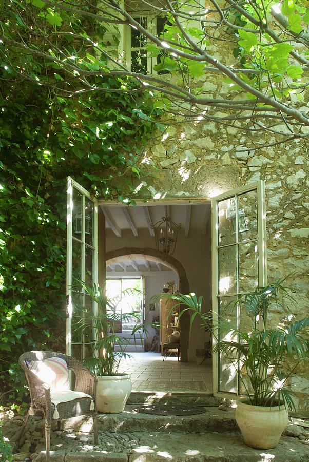 Shady Seating Area In Front Of Farm House With Open Terrace Door And ...