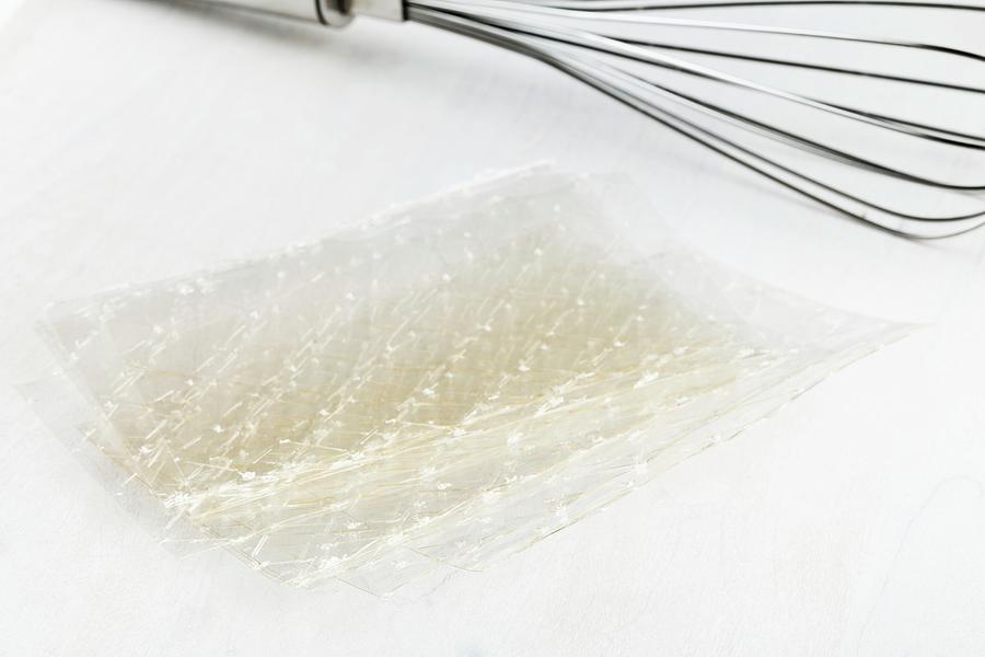 Sheets Of Gelatine On A Wooden Board With A Whisk Photograph by Shawn Hempel