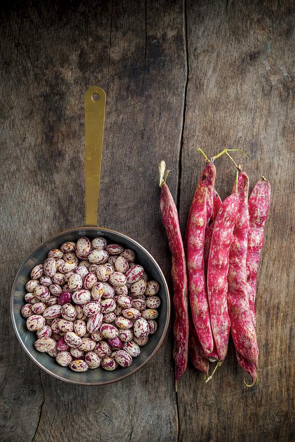 Shelled And Whole Borlotti Beans On Wooden Board Photograph by Nitin Kapoor