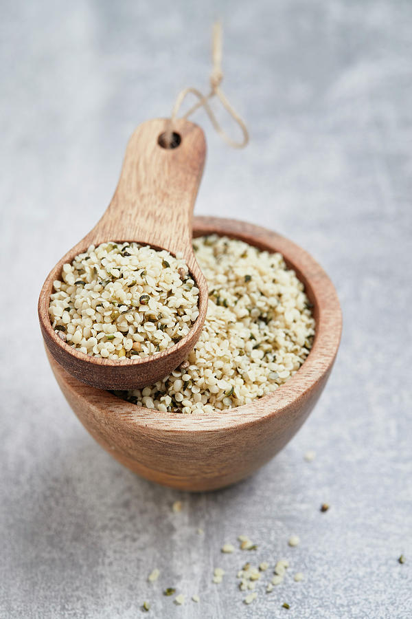 Shelled Hemp Seeds In A Wooden Bowl And A Wooden Scoop Photograph by Brigitte Sporrer
