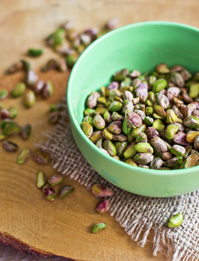 Shelled Pistachios In A Small Bowl And Next To It Photograph by Dorota Indycka