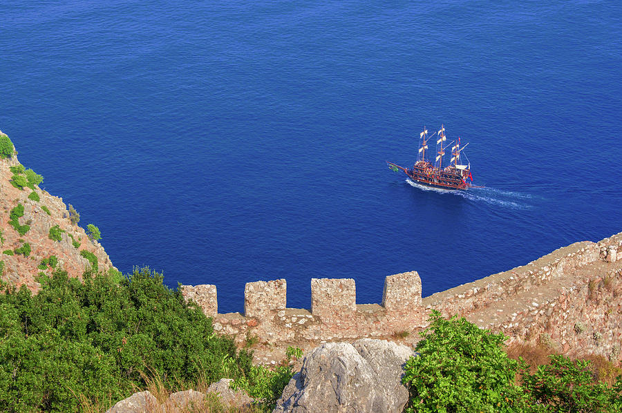 Ship in front of Alanya Castle Photograph by Sun Travels