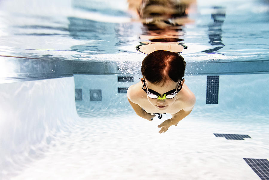 Shirtless Boy Swimming Underwater In Pool Photograph by Cavan Images ...