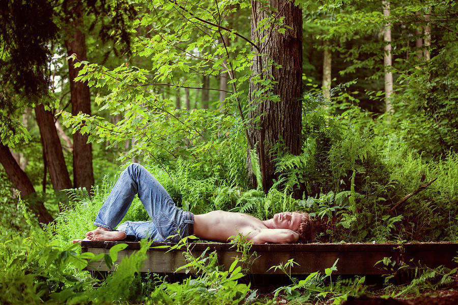 Shirtless Man Lying On Pier In Forest Photograph by Cavan Images - Fine ...