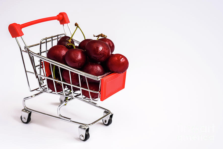 Shopping cart full of ripe cherries, healthy and nutritious shopping full of vitamins to feed children with fruits. Photograph by Joaquin Corbalan