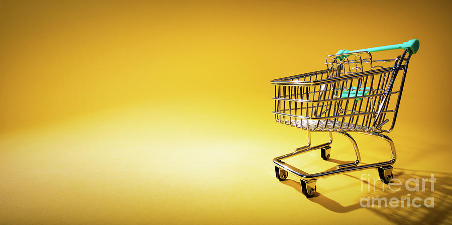 Basket Photograph - Shopping cart on yellow background in spotlight by Michal Bednarek
