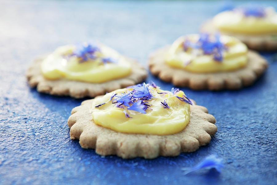 Shortbread Biscuits Topped With Lemon Curd And Cornflowers On A Blue Surface Photograph by Nika Moskalenko