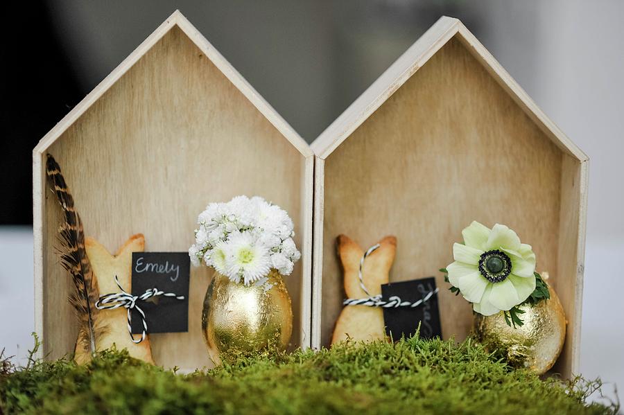 Shortbread Rabbits And Gilt Eggs Used As Vases In Small, Chip Wood Houses Photograph by Alexandra Feitsch