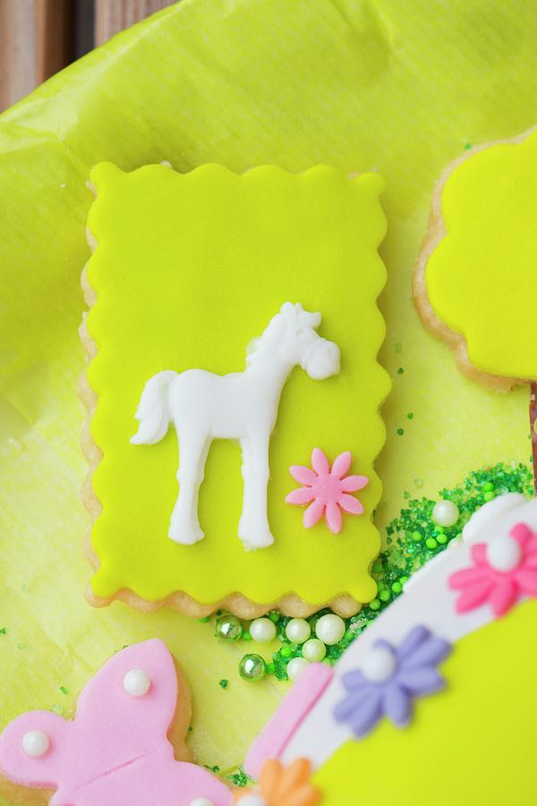 Shortcrust Biscuits Decorated With Green Fondant Icing, Flowers And A Horse Photograph by Esther Hildebrandt