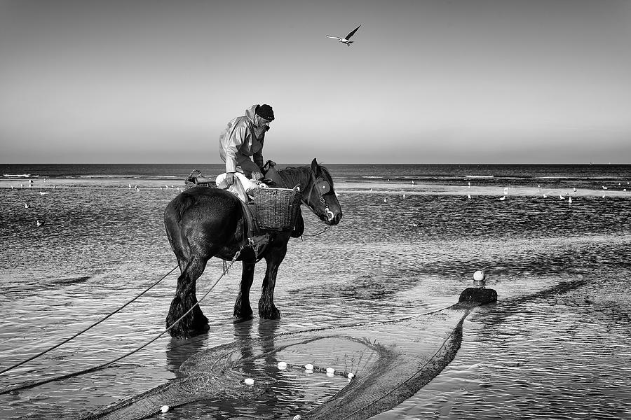 Black And White Photograph - Shrimp Fisherman On Horseback by Christian Delvaux