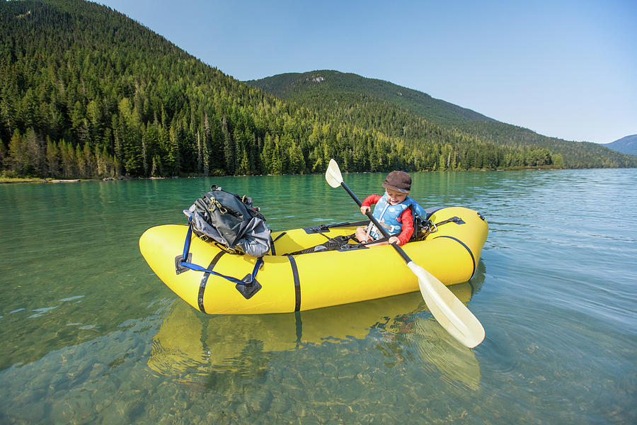 Side Vewi Of Young Boy Paddling Yellow Inflatable Kayak On Calm Lake ...