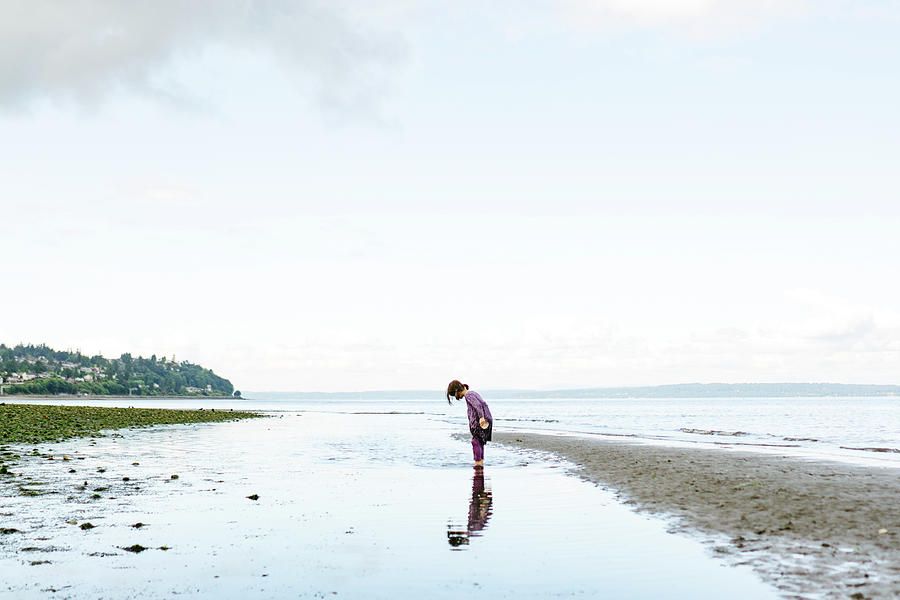 Seattle Photograph - Side View Of A Young Child Looking Down At Her Reflection In The Water by Cavan Images
