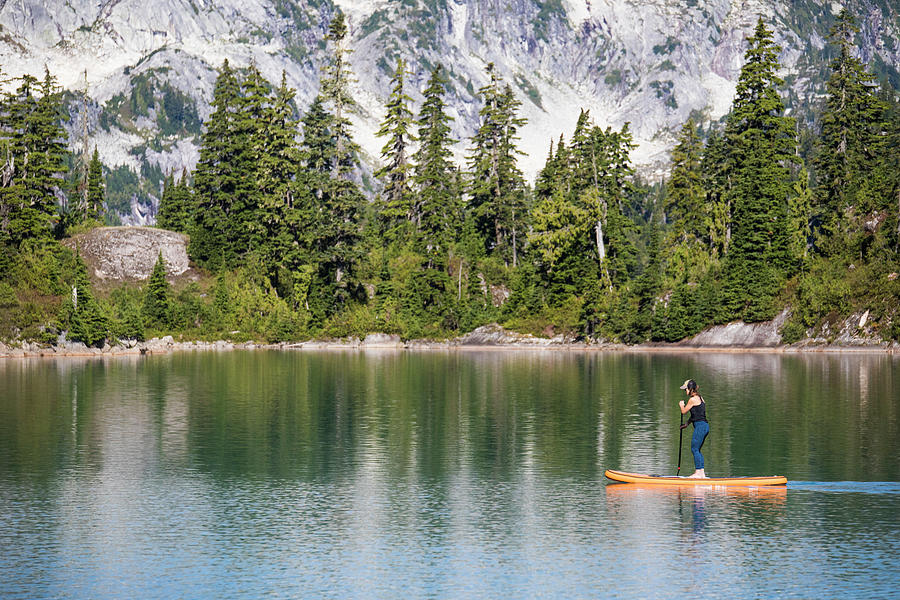 Side View Of Active Woman Paddle Boarding On Mountain Lake. Photograph by Cavan Images