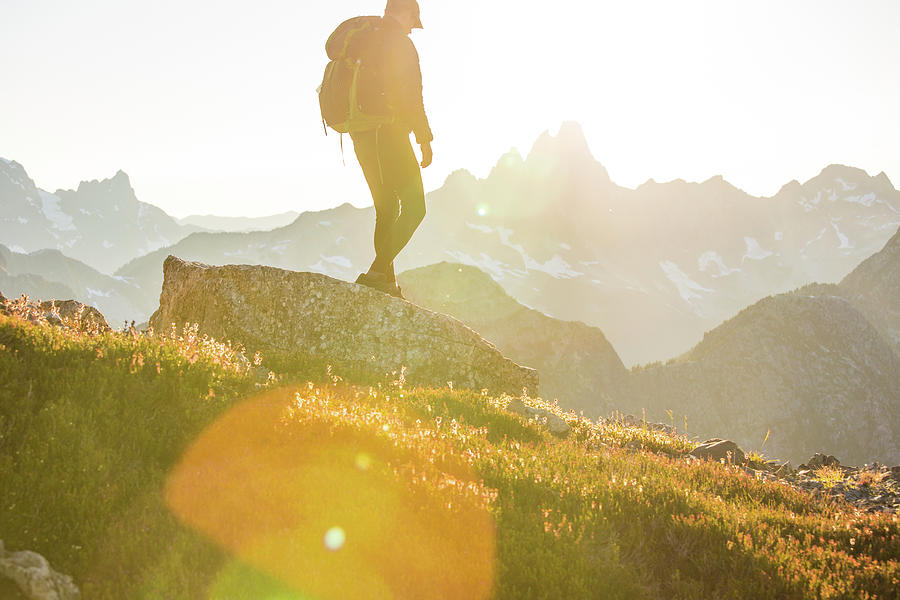 Side View Of Hiker Backpacking Across A High Mountain Range. Photograph 