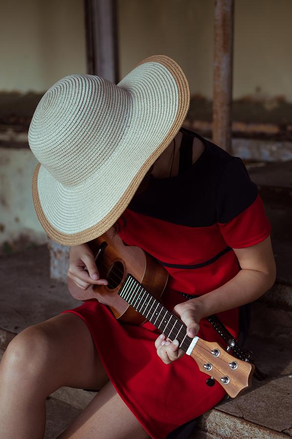 Music Photograph - Side View Of Sitting Girl In Hat, Playing Ukulele, On Old Steps by Cavan Images