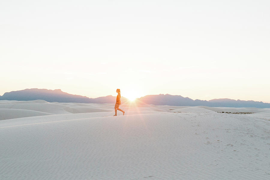 White Sands National Monument Photograph - Side View Of Woman Walking At White Sands National Monument Against Clear Sky During Sunset by Cavan Images
