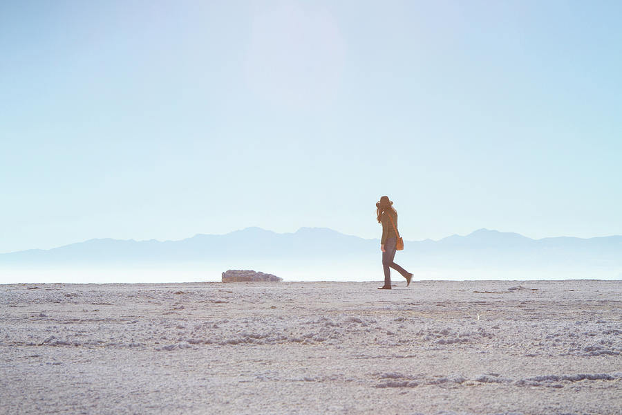 Nature Photograph - Side View Of Woman Walking On Field Against Clear Sky At Antelope Island by Cavan Images