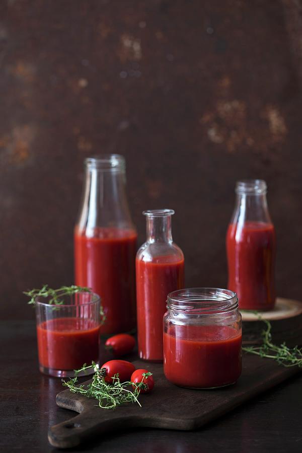Sieved Tomatoes In Jars And Bottles Photograph by Malgorzata Laniak