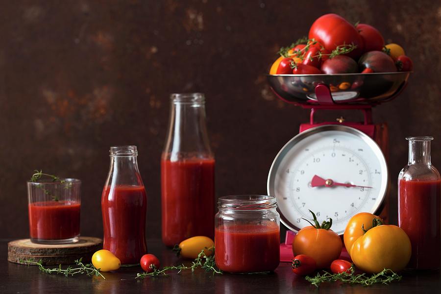 Sieved Tomatoes In Jars And Bottles With Fresh Tomatoes On A Pair Of Kitchen Scales Photograph by Malgorzata Laniak