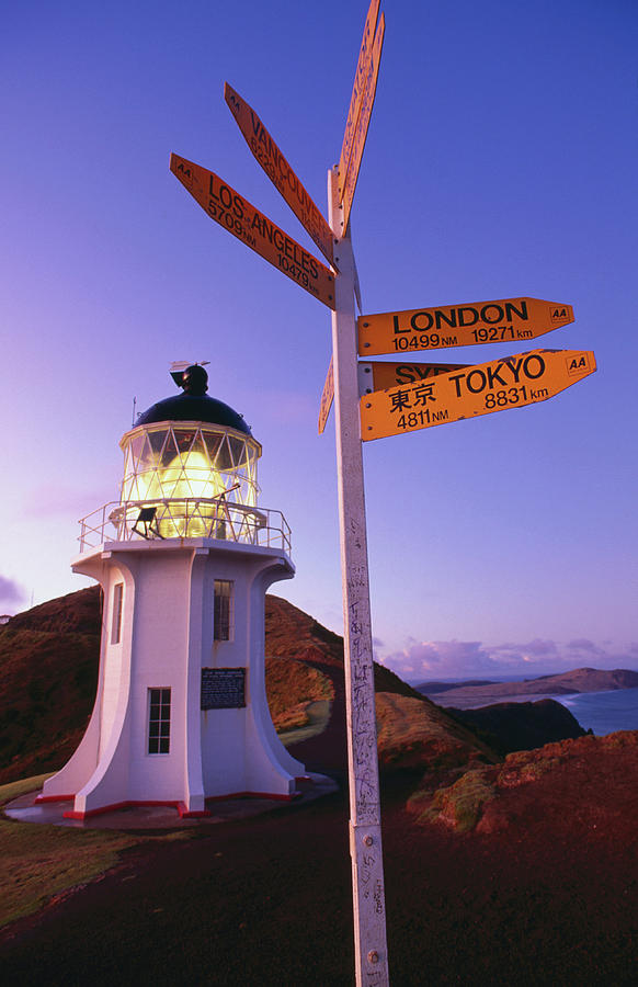 Signpost In Front Of Lighthouse At Photograph by Oliver Strewe