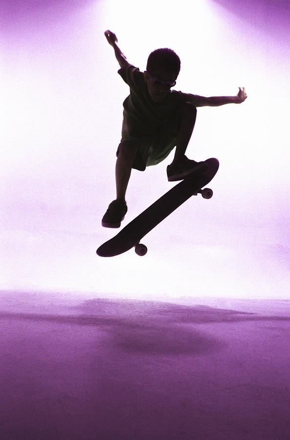 Sports Photograph - Silhouette Of A Boy Skateboarding by Artist - Unknown