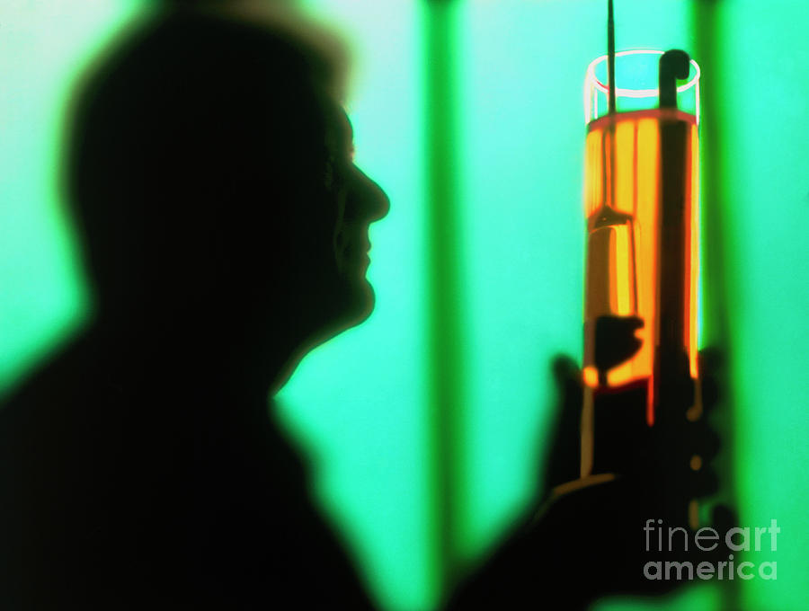 Silhouette Of A Chemist Holding A Glass Cylinder Photograph by Jesse/science Photo Library