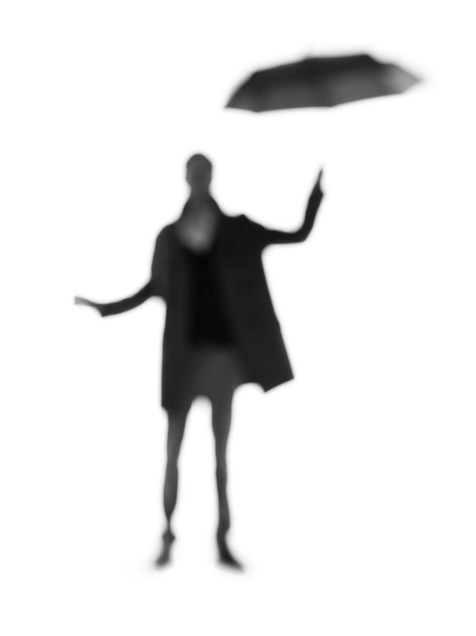Silhouette Of A Man With An Umbrella Photograph by Peter Rutherhagen