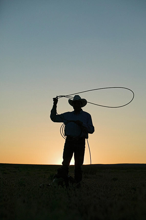 Silhouette Of Cowboy With Lasso Photograph by Edward Mccain