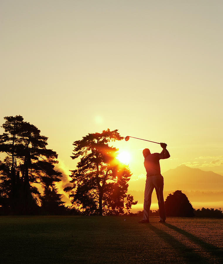 Silhouette Of Golfer Swinging Club On Photograph by Thomas Northcut