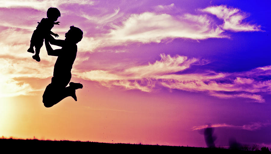 Silhouette Of Man And Boy Jumping In Air Photograph by Leon Truong
