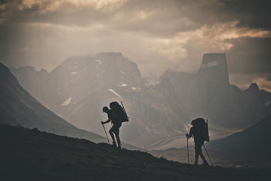 Mountain Photograph - Silhouette Of Two Backpackers Hiking With Rugged Mountain View. by Cavan Images
